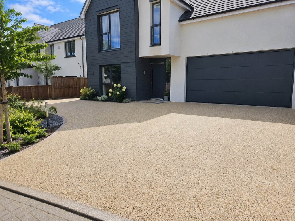 Caramel Latte resin bound driveway on modern detached home with dark cladding by Windsor Resin Driveways