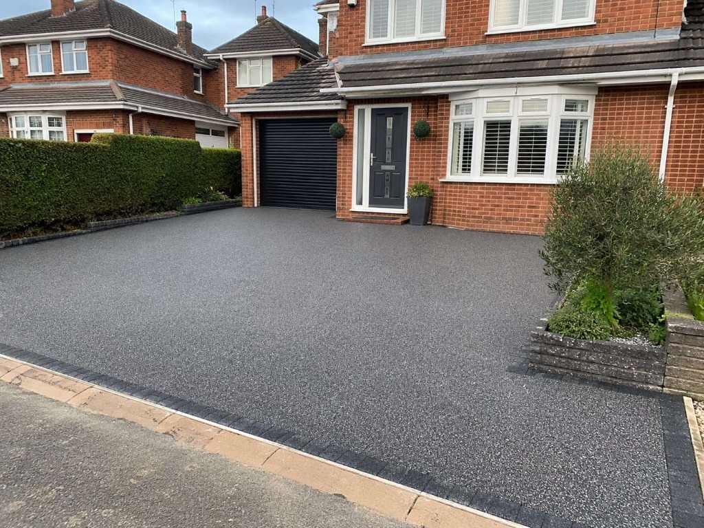 Dark Grey resin bound driveway on semi-detached red brick property by Windsor Resin Driveways